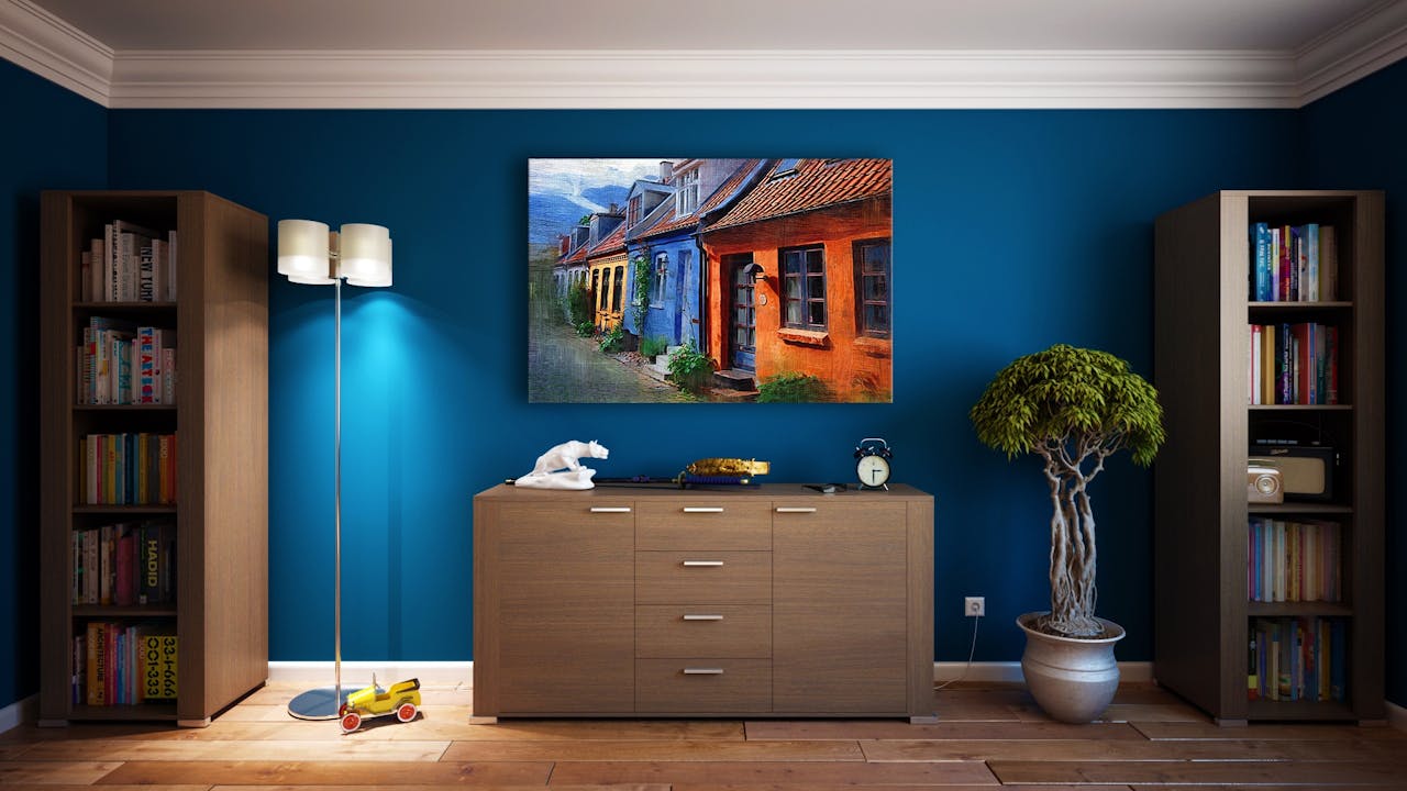 our-mission-01 A modern living room featuring stylish bookshelves, a vibrant painting, and minimalistic decor.